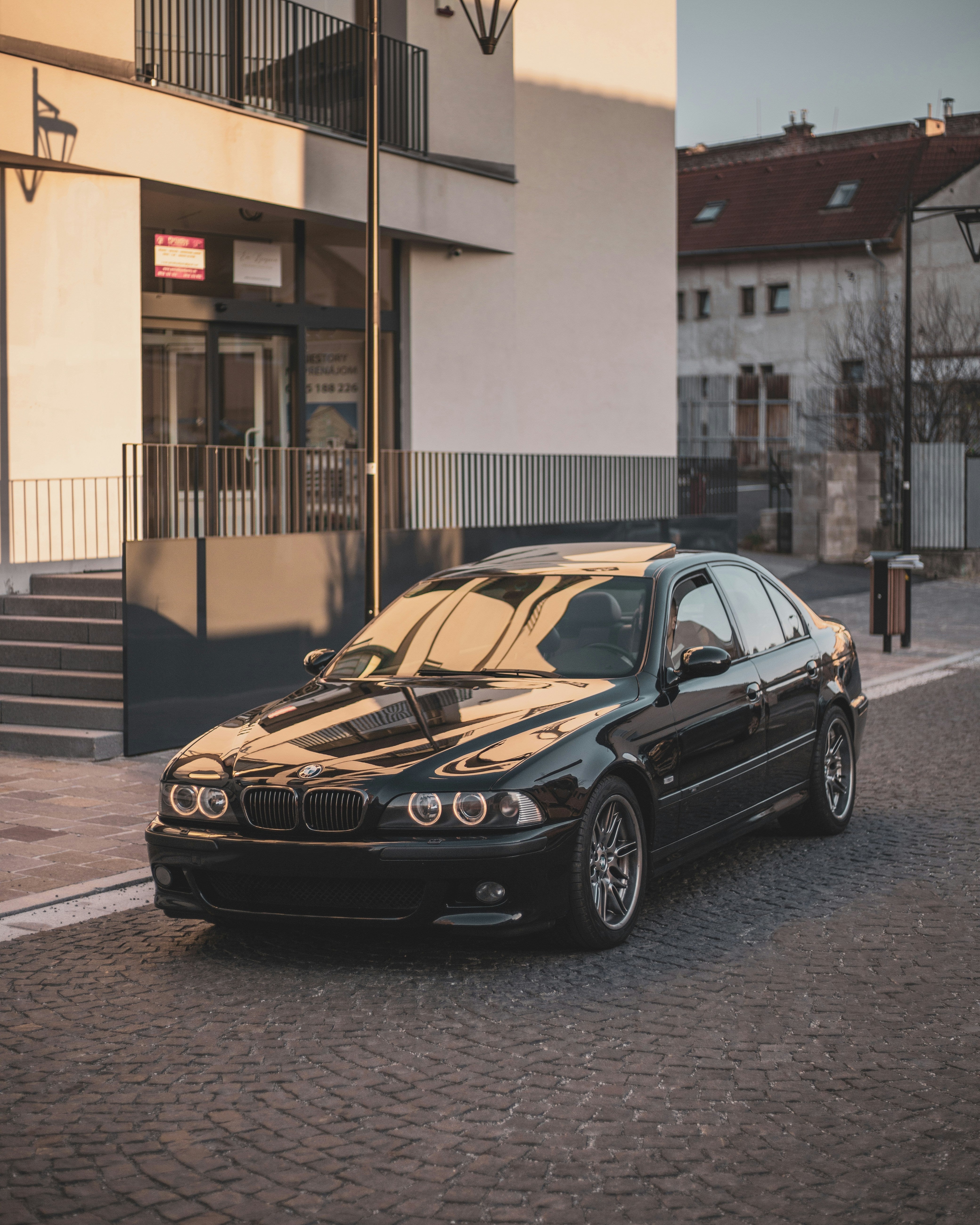 BMW E39 5 series in front of building