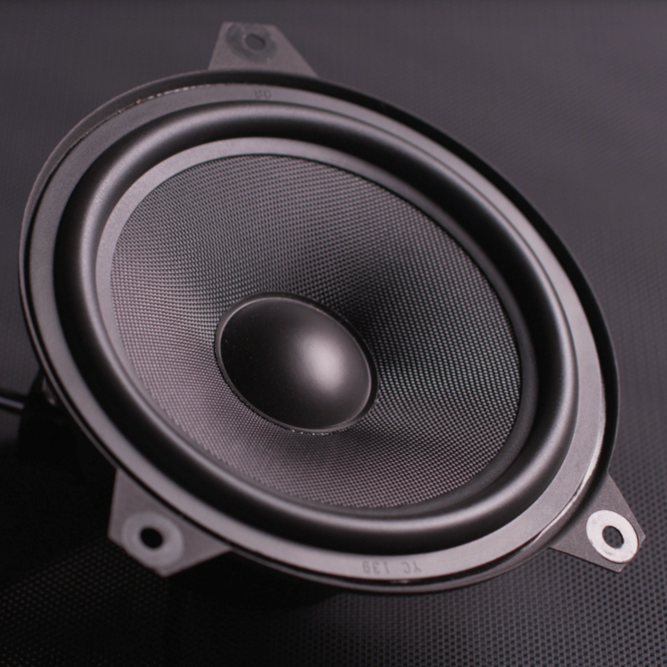 Close up image of a Bavsound speaker on a dark gray background.